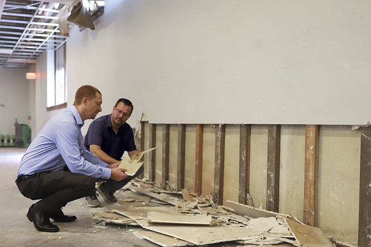 An associate from the Glatfelter Claims team looks over damage in a church from recent flooding.
